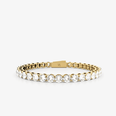 This is a front on product shot of our 5mm yellow gold tennis bracelet displayed on a white background with the clasp