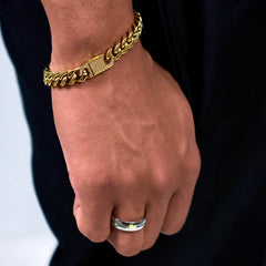 This is a close-up shot of our 10mm yellow gold cuban link bracelet on a models wrist