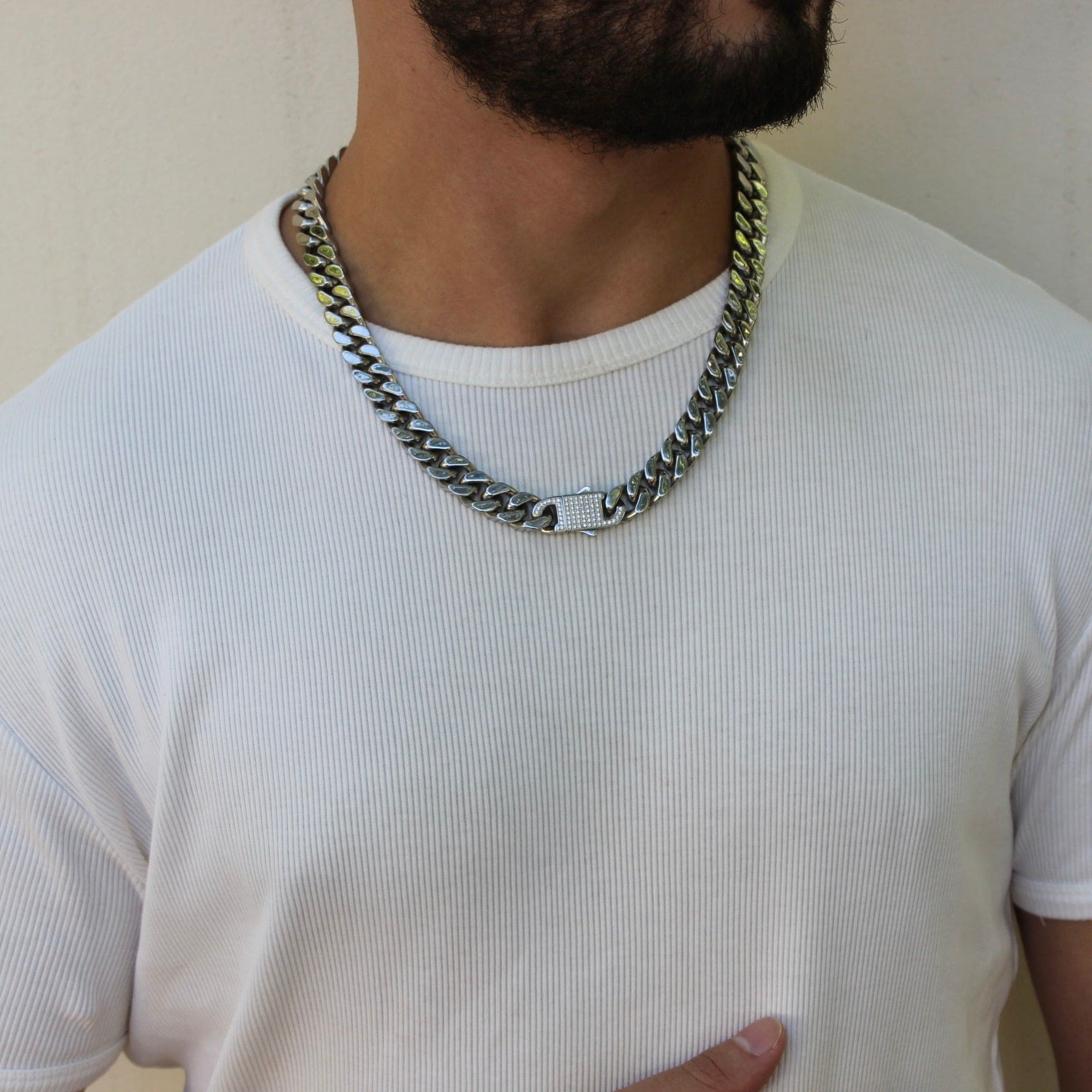 This is a mid shot of our 12mm cuban link chain with our signature Cz clasp being shown