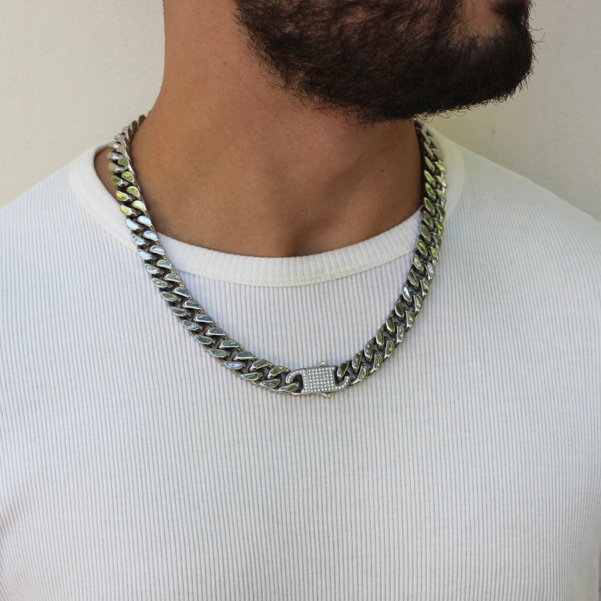 This is a mid shot of our 12mm cuban link chain with our signature Cz clasp being shown