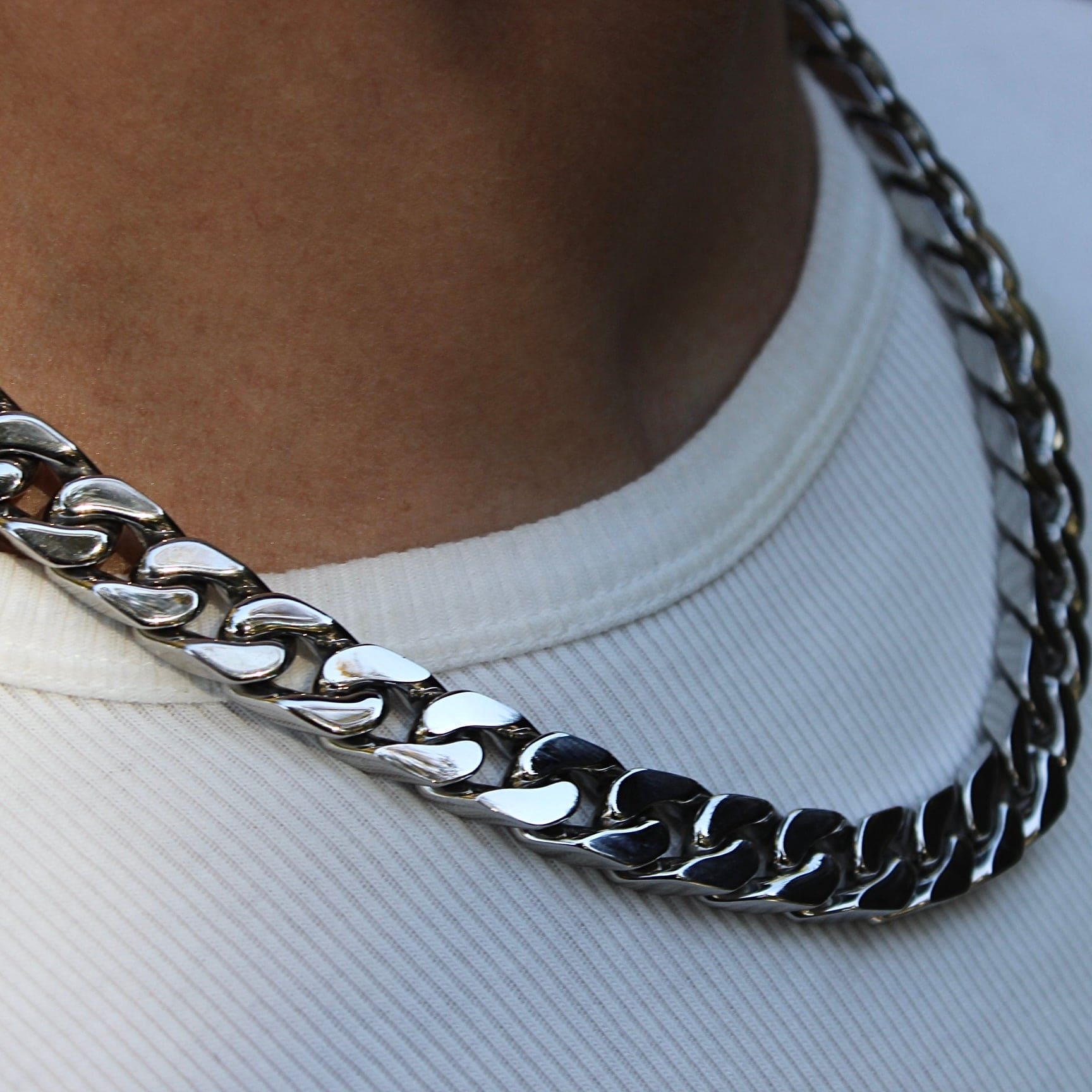 This is a close up shot of our 12mm cuban link chain necklace on our models neck 