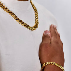 This is a front shot of a a model wearing our 12mm Yelllow gold Rhombus cuban link chain, no clasp is being displayed