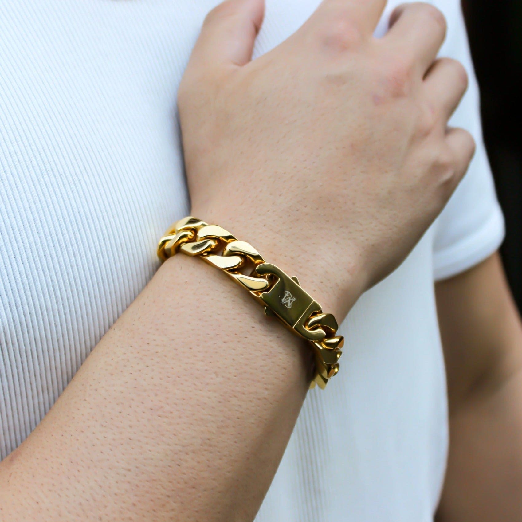 This is a close up shot of our 12mm Yellow Gold Cuban bracelet on our models wrist