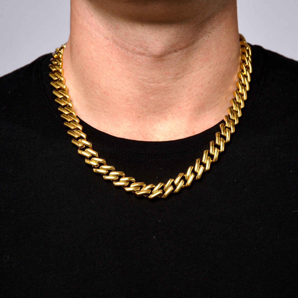 This is a front shot of a a model wearing our 12mm Yelllow gold Rhombus cuban link chain, no clasp is being displayed