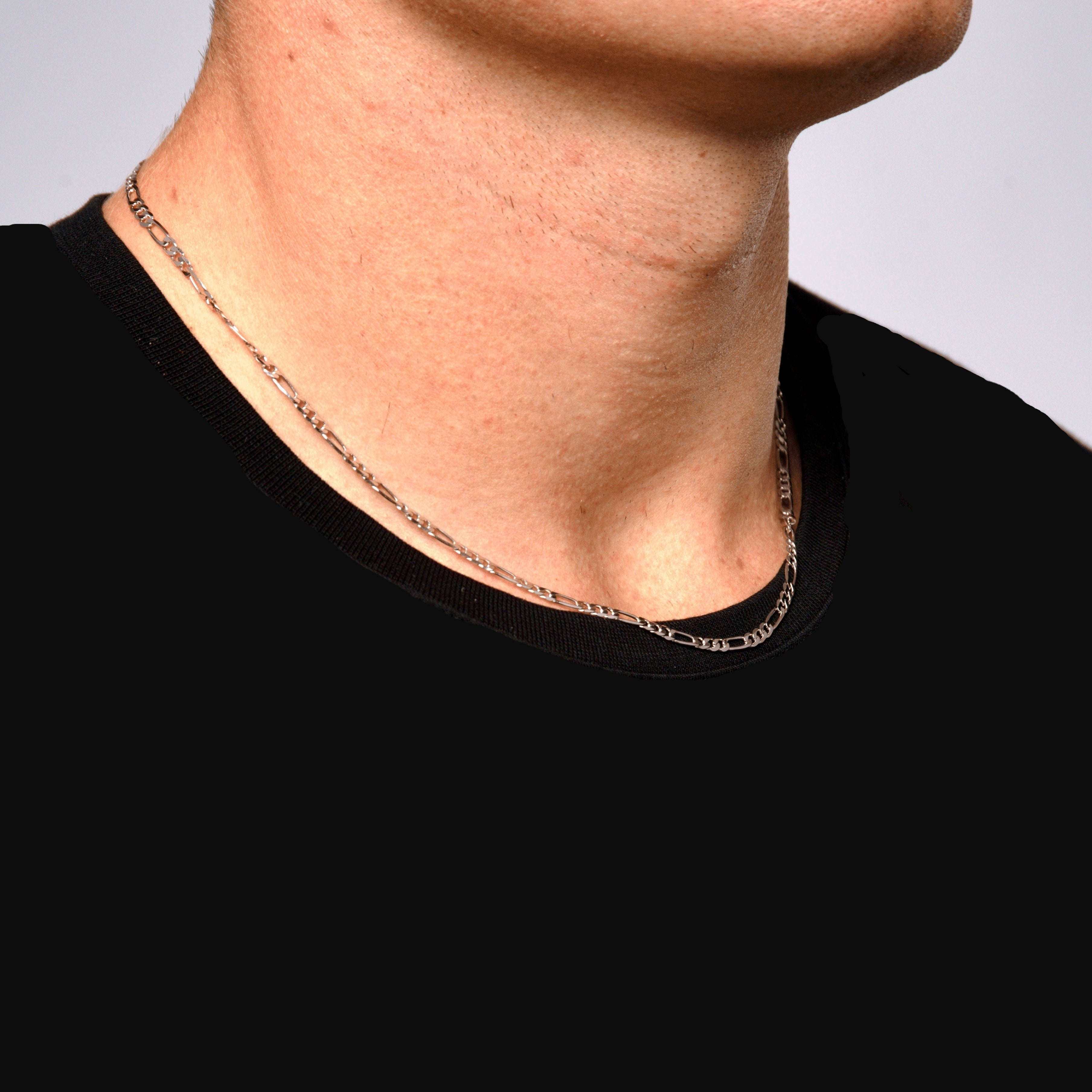 This is a side closeup shot of our 3mm sterling silver figaro chain on a models neck.