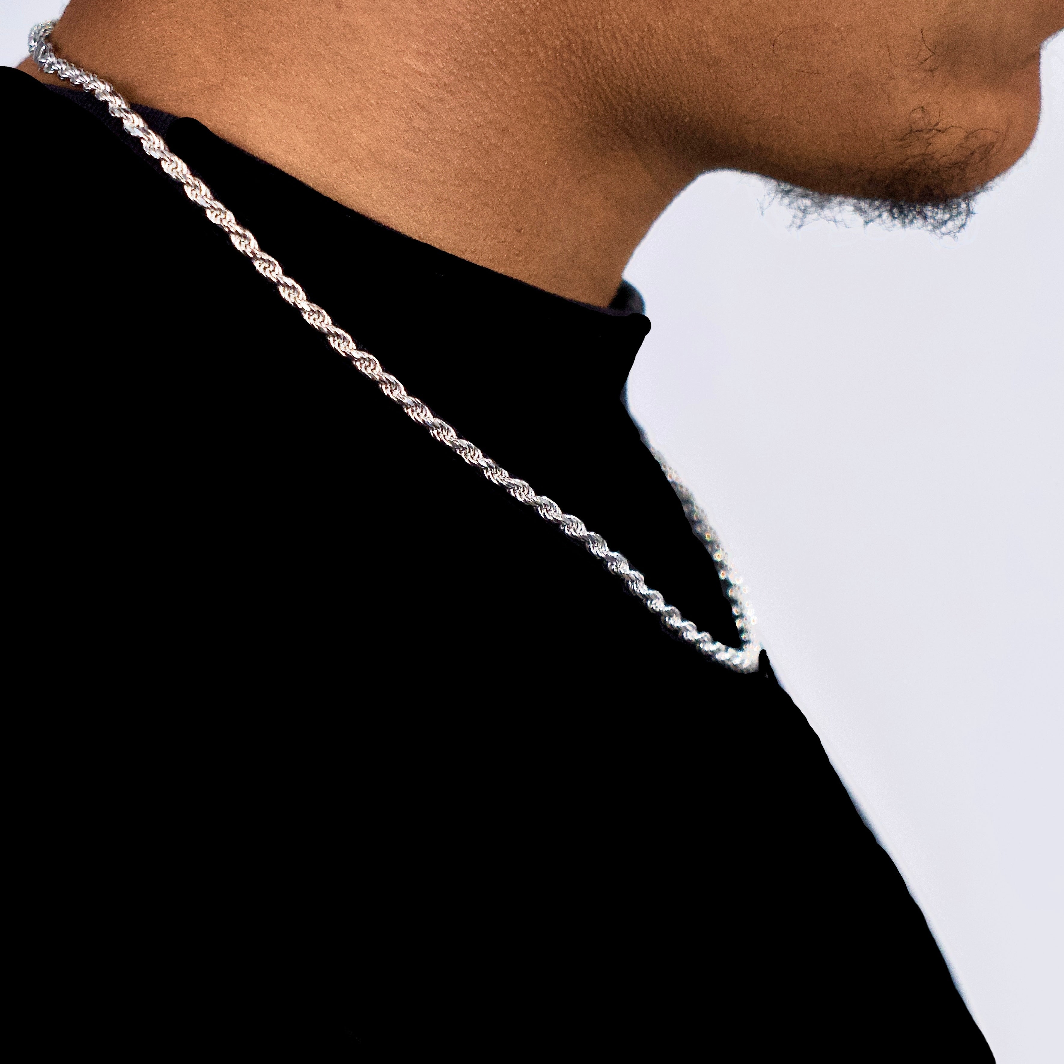 This is a side shot of our 3mm diamond cut sterling silver rope chain sitting on a models neck.