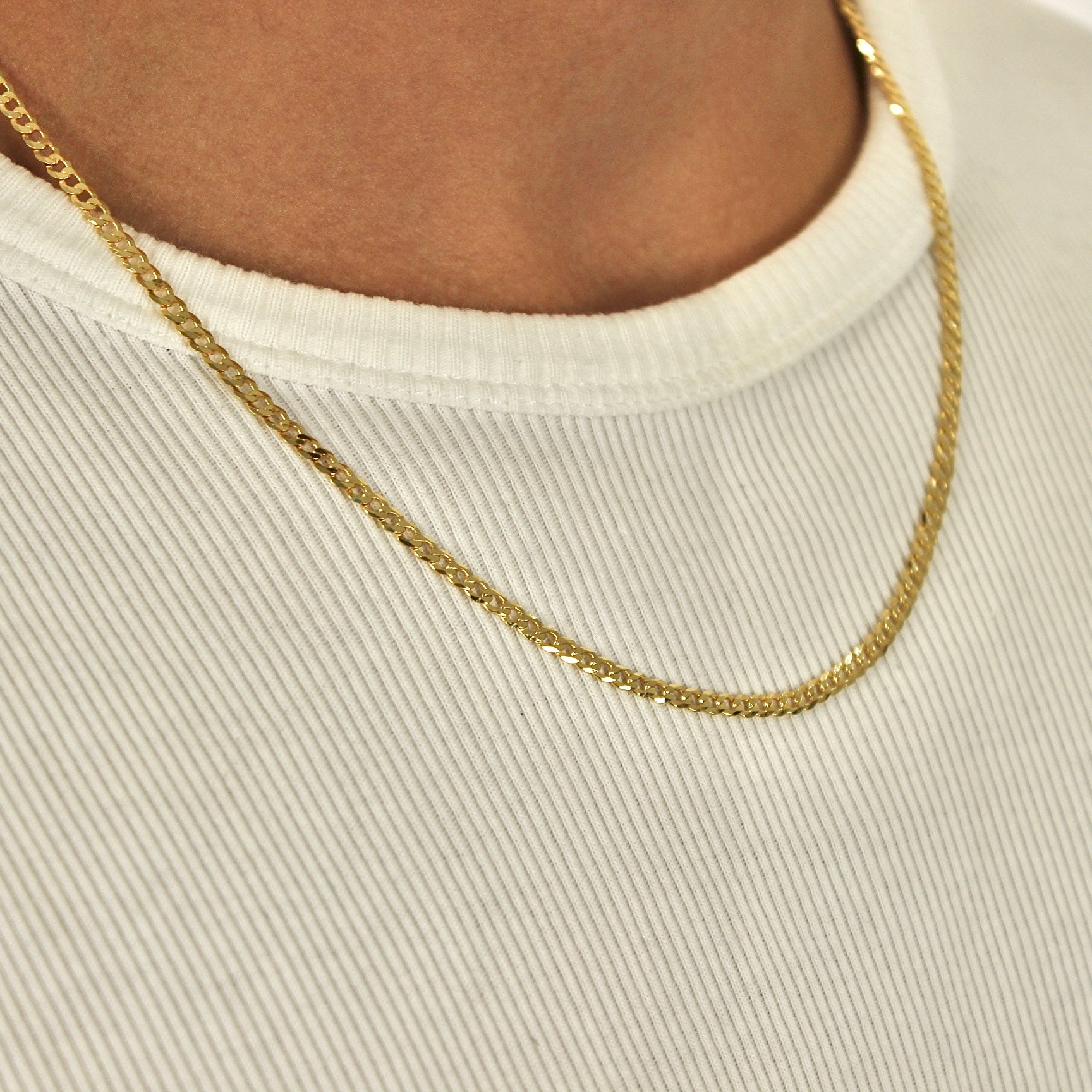 This is a close up side shot of our 3mm yellow gold plated sterling silver curb chain necklace being showcased on a models neck