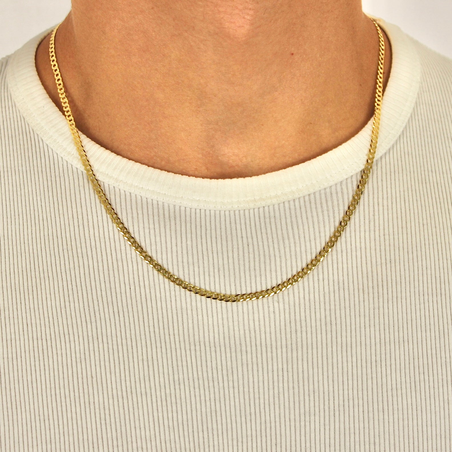 This is a close up front shot of our 3mm yellow gold plated sterling silver curb chain necklace being showcased on a models neck