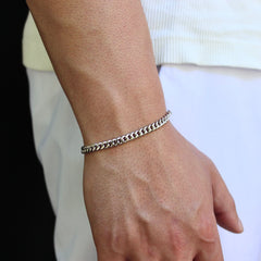 This is a close-up shot of our 5mm sterling silver cuban bracelet on our models wrist with the models