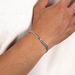 This is a mid shot of a model show casing our 5mm sterling silver curb bracelet