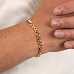 This is an extreme close up shot of our 5mm yellow gold curb bracelet on our models wrist