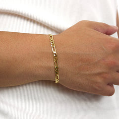 This is a close up shot of our 5mm yellow gold figaro bracelet (sterling silver) on our models wrist.