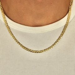 This is a closeup shot of our 5mm yellow gold curb chain on a models neck.