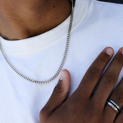 this is a close up shot of our 5mm sterling silver cuban link chain on a models neck