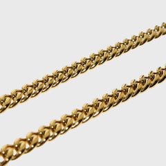 This is an extreme close-up product shot of our 6mm yellow gold cuban chain on a white backround