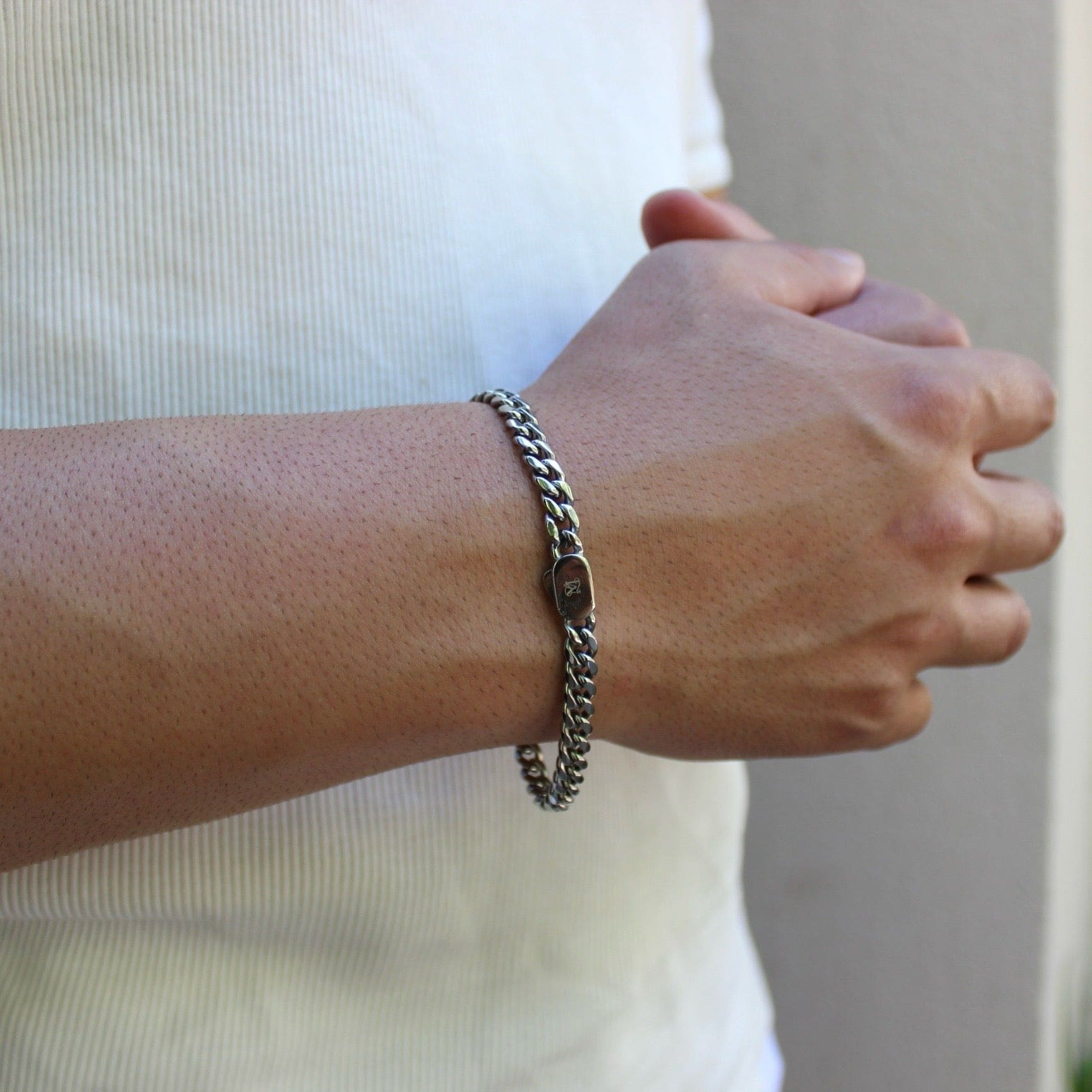 This is a closeup shot of our 6mm cuban bracelet with our box clasp being shown on our models wrist