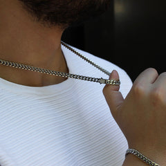 This is a close up side shot of our 6mm cuban link chain necklace on our models neck. This is taken in public Scenery 