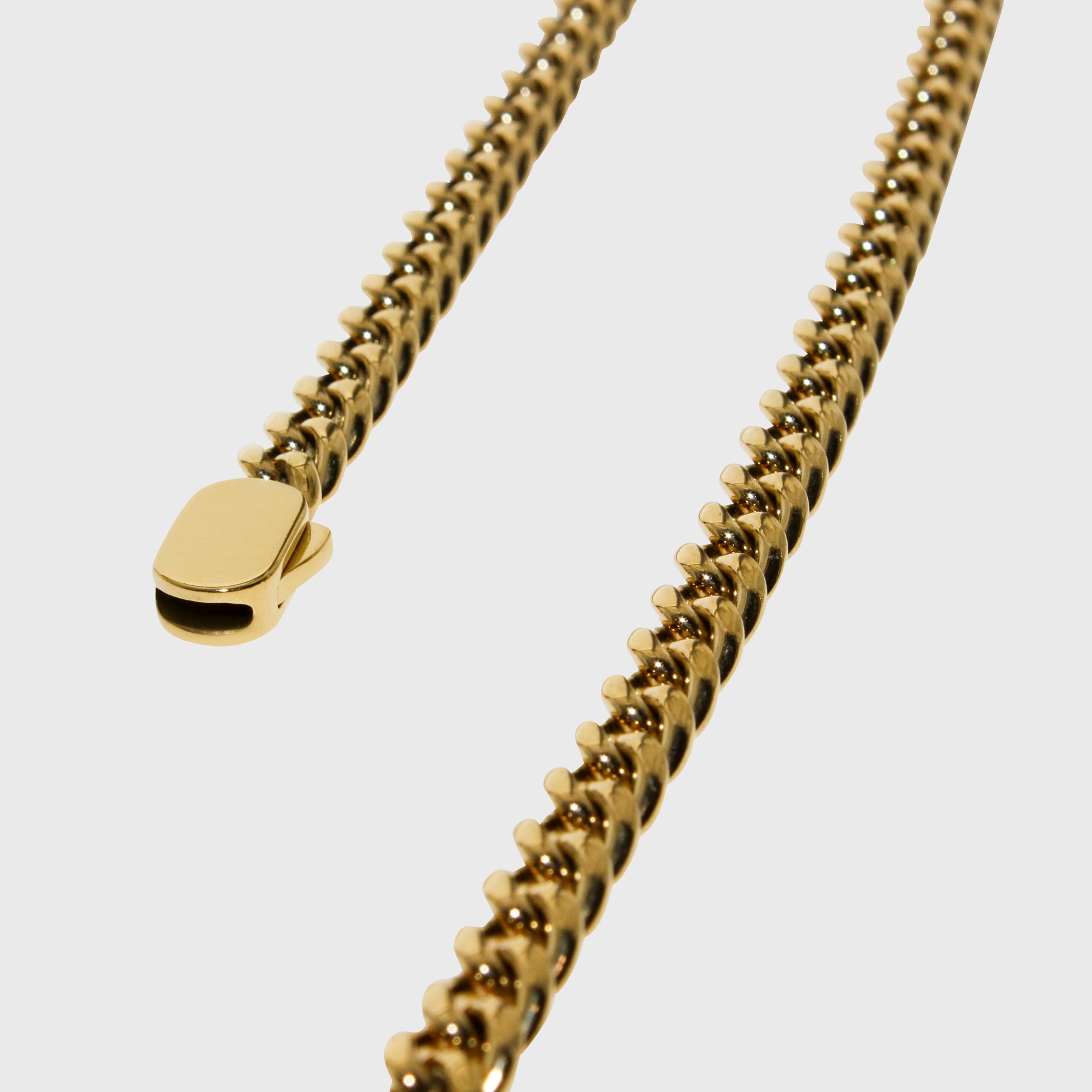 This is a front-on product shot of our 6mm yellow gold cuban link chain, displayed on a white background with a front view of the necklace clasp