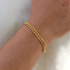 This is a close up side shot of what our 6mm yellow gold cuban bracelet looks like on our models wrist