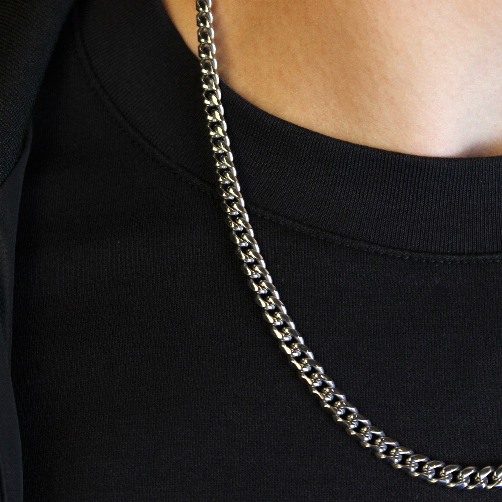 This is a close up side shot of our 6mm cuban link chain on a models neck.