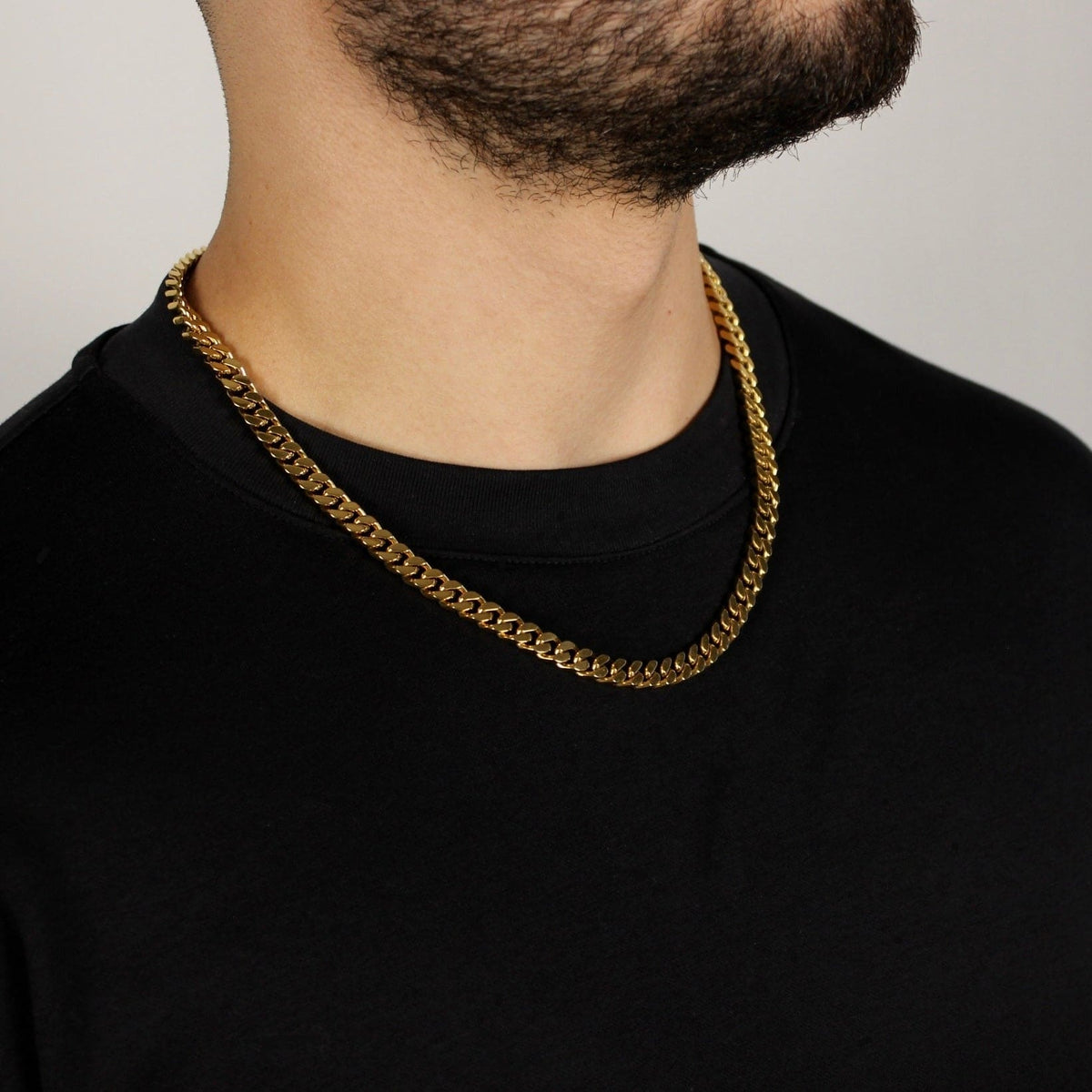 This is mid shot of our 6mm stainless steel yellow gold cuban link chain on our models neck