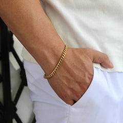 This is a side shot of our 6mm yellow gold cuban bracelet on a models hand with the models hand in there pocket