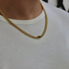 This is a close up shot of our 6mm yellow gold cuban link chain on our models neck with the clasp being shown