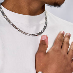 This is a close up front shot of our 7mm sterling silver figaro chain on our models neck