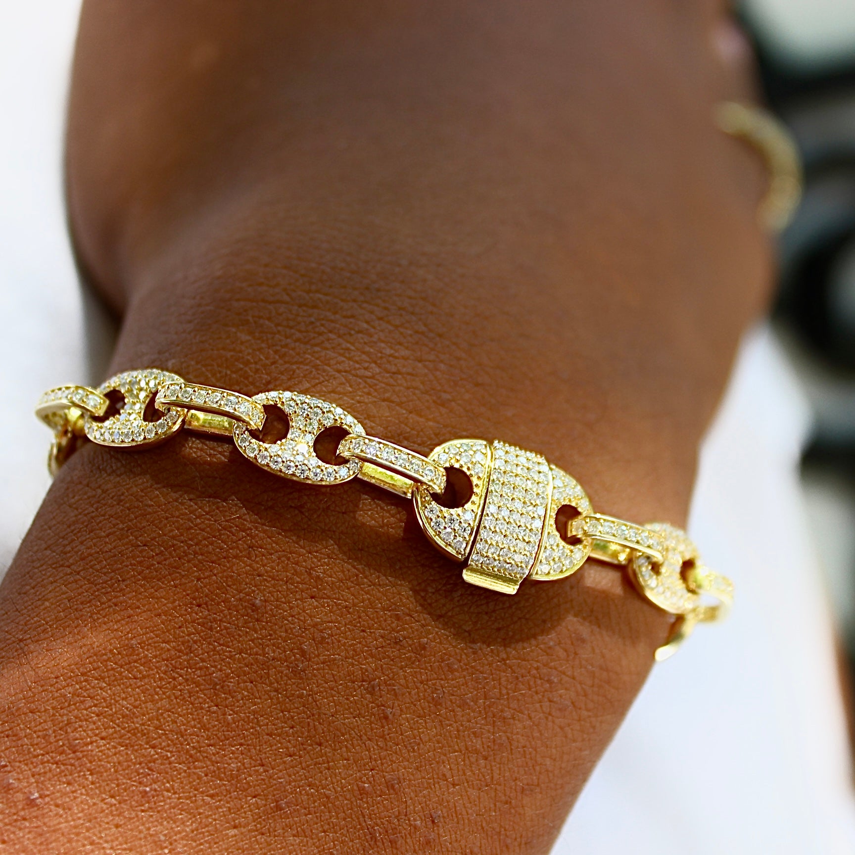 This is a close up shot of our solid 8mm 10k yellow gold morg-link bracelet on a models wrist