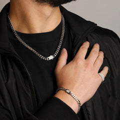 This is a mid shot of our model styling our 8mm cuban link chain (stainless steel) and pairing it with a bracelet and ring