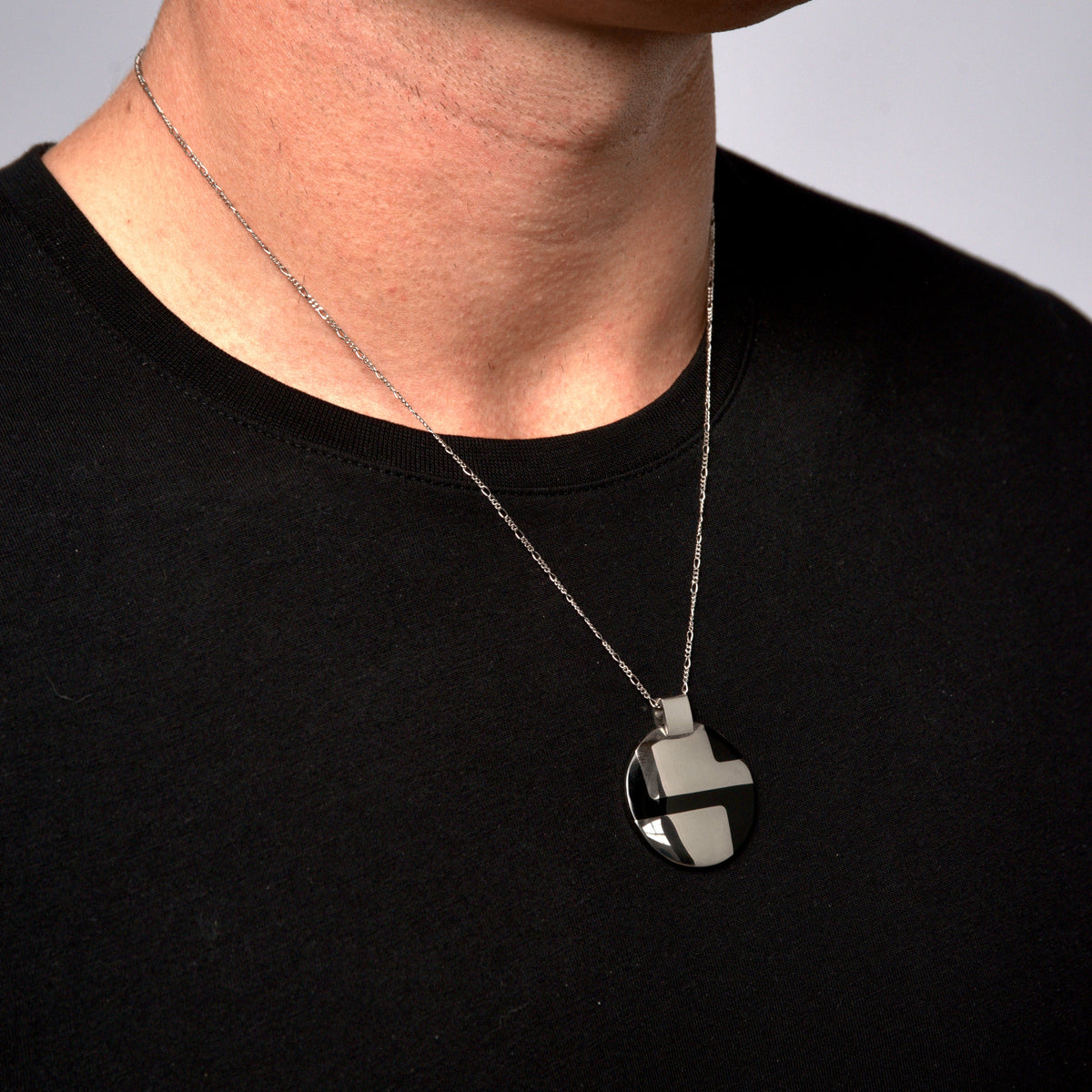 This is a mide close up shot of our Lencia Lume designer Pendant being displayed on our models neck