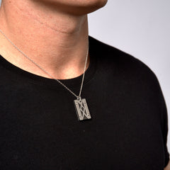 This is a close up shot of our L&M signature designer pendant on our models neck