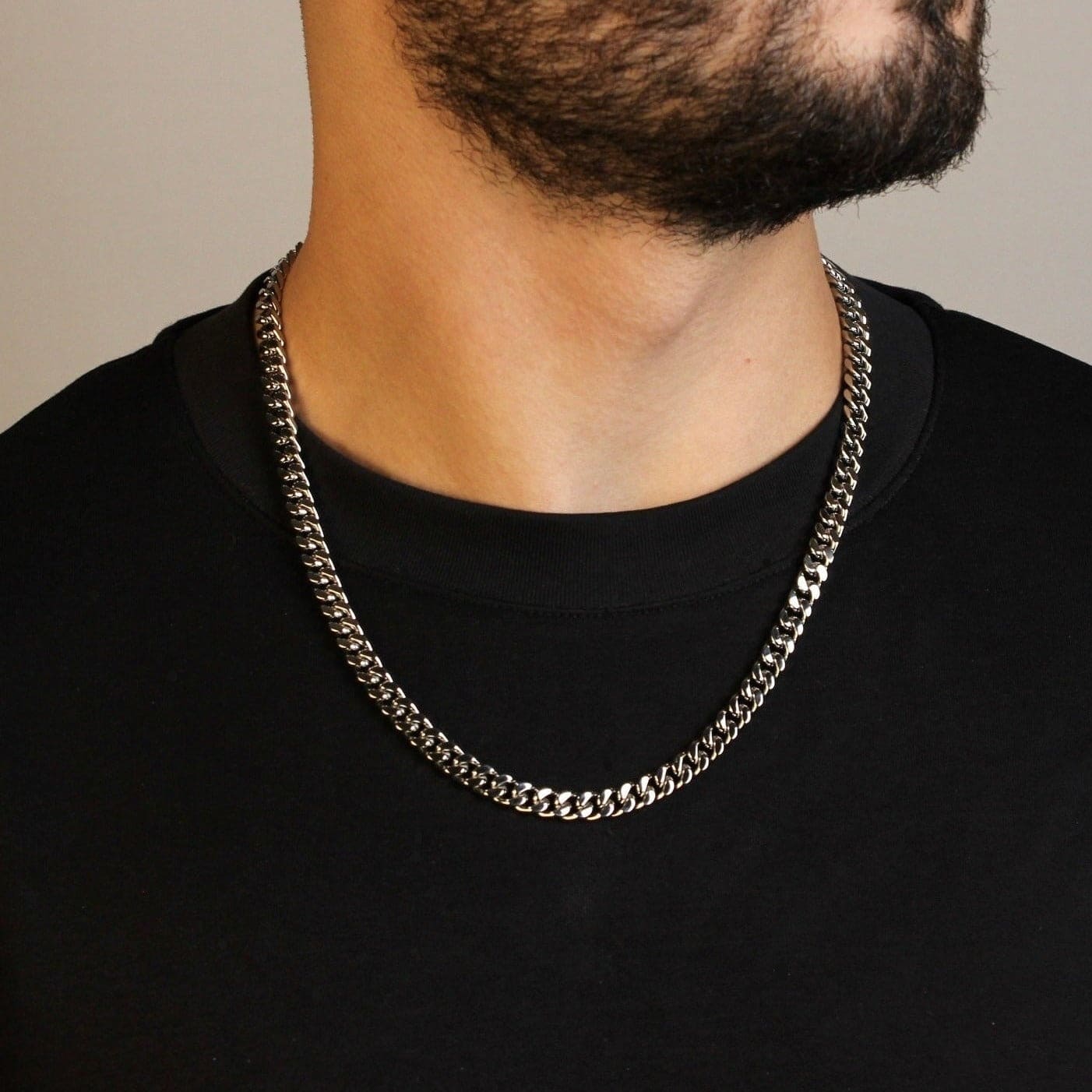 This is a model shot of our 8mm stainless steel cuban link chain on our models neck.