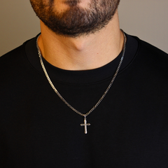 This is a close up shot of our Sterling Silver cross pendant with black Cz on a models neck 