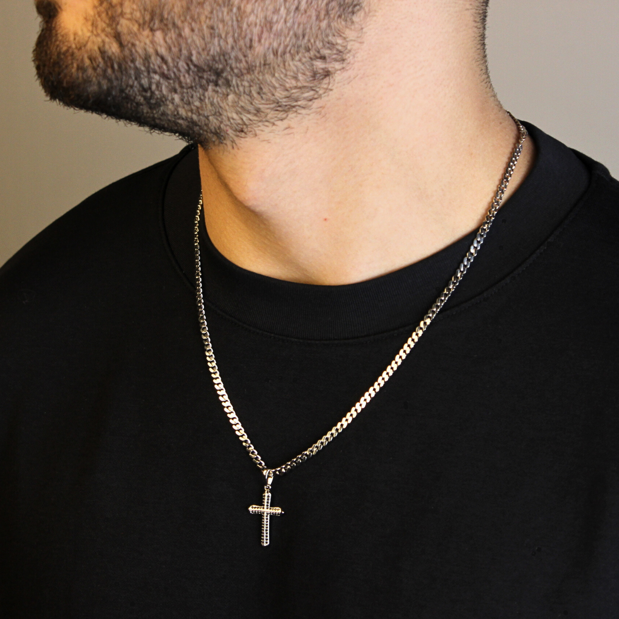 This is a side model shot of our Sterling Silver Cross pendant with black cz on our models neck wearing our 3mm sterling silver curb chain neckalace