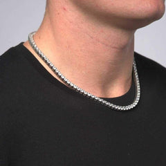 This is a side shot taken in a studio of a model wearing our 5mm Stainless Steel Tennis Necklace